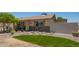 View of the home's exterior with stone accents and a grassy patch accenting the xeriscaped front yard at 6802 S 47Th St, Phoenix, AZ 85042