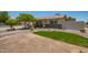 View of the home's exterior with stone accents and a grassy patch accenting the xeriscaped front yard at 6802 S 47Th St, Phoenix, AZ 85042