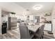 Modern kitchen featuring white cabinets, stainless steel appliances, open shelves, and a dining area at 6802 S 47Th St, Phoenix, AZ 85042