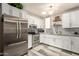 Modern kitchen with stainless steel appliances, white cabinetry, and stylish backsplash at 6802 S 47Th St, Phoenix, AZ 85042