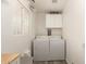 Efficient laundry room with a window, overhead storage, and updated washer and dryer at 6802 S 47Th St, Phoenix, AZ 85042