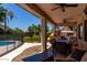 Inviting backyard with covered patio, outdoor dining, pool, and play structure at 735 W Kelton Ln, Phoenix, AZ 85023