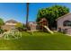 Lush backyard with a play area, artificial grass and plenty of room to play at 735 W Kelton Ln, Phoenix, AZ 85023
