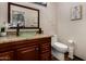 Bathroom boasts granite countertops, glass bowl sink, bronze faucet, and wood cabinets at 735 W Kelton Ln, Phoenix, AZ 85023