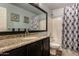 Charming bathroom with granite counters, dark cabinetry, and a shower-tub combo at 735 W Kelton Ln, Phoenix, AZ 85023