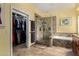 Bathroom features glass shower, tub and walk in closet at 735 W Kelton Ln, Phoenix, AZ 85023