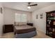 Cozy bedroom with a comfortable bed, side tables, a bookcase and neutral decor at 735 W Kelton Ln, Phoenix, AZ 85023