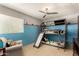 Bright bedroom featuring bunk beds with a slide, a cozy armchair, and a playful, colorful design at 735 W Kelton Ln, Phoenix, AZ 85023