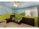 room has custom paint, ceiling fan, and wood dresser at 735 W Kelton Ln, Phoenix, AZ 85023