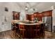 Gourmet kitchen featuring a large island with bar seating, modern appliances and ample cabinetry at 735 W Kelton Ln, Phoenix, AZ 85023