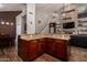 Open kitchen features a large center island, custom cabinetry, laminate wood floors, and pendant lighting at 735 W Kelton Ln, Phoenix, AZ 85023