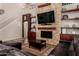 Bright living room featuring a stone fireplace, built-in shelves and soaring ceilings at 735 W Kelton Ln, Phoenix, AZ 85023