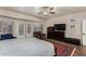 Large main bedroom boasts wooden floors, ceiling fan, french door access to patio and pool at 735 W Kelton Ln, Phoenix, AZ 85023