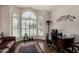 Comfortable home office with built-in desk, ample natural light, and laminate wood flooring at 735 W Kelton Ln, Phoenix, AZ 85023