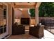 Cozy outdoor seating area with a fireplace and lush greenery, perfect for relaxing evenings at 735 W Kelton Ln, Phoenix, AZ 85023