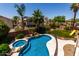 Inviting backyard pool and spa with mature landscaping and a fun playground for endless outdoor enjoyment at 735 W Kelton Ln, Phoenix, AZ 85023