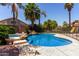 Inviting backyard with a pool, hot tub, rock waterfall feature, and tropical landscaping at 735 W Kelton Ln, Phoenix, AZ 85023