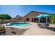 The backyard features a fenced in pool, gravel beds, and a covered patio at 757 W Carob Way, Chandler, AZ 85248