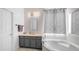 Bathroom with soaking tub, vanity with updated fixtures and tile flooring at 757 W Carob Way, Chandler, AZ 85248