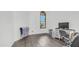 A bedroom featuring modern wood flooring and a arched window at 757 W Carob Way, Chandler, AZ 85248