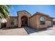 Charming home exterior with arched entry, neutral stucco, and desert landscaping at 757 W Carob Way, Chandler, AZ 85248