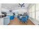 Spacious eat-in kitchen with blue cabinets, an island, dining table and recessed lighting with a ceiling fan at 757 W Carob Way, Chandler, AZ 85248