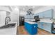 Spacious kitchen featuring blue cabinets, an island, stainless steel appliances, and modern fixtures at 757 W Carob Way, Chandler, AZ 85248