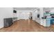Expansive living area with neutral tile flooring, white walls, and a seamless connection to the kitchen area at 757 W Carob Way, Chandler, AZ 85248