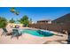 A refreshing private pool includes a diving board, sun umbrella, and patio set at 757 W Carob Way, Chandler, AZ 85248