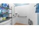 Accessible shower with tiled walls, grab bars, and convenient shower caddy at 757 W Carob Way, Chandler, AZ 85248