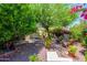 Secluded backyard offers an outdoor kitchen, seating area, and mature trees at 7635 S Taylor Dr, Tempe, AZ 85284