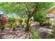 Beautiful backyard with mature trees, flowering plants, and multiple seating areas, ideal for outdoor enjoyment at 7635 S Taylor Dr, Tempe, AZ 85284