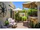 Serene patio with comfortable seating, outdoor bar, shade umbrellas, and lush plants, creating a tranquil retreat at 7635 S Taylor Dr, Tempe, AZ 85284