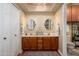 Elegant bathroom boasts double vanity, cherry wood cabinets, and stylish overhead lighting at 7635 S Taylor Dr, Tempe, AZ 85284