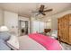 Spacious bedroom with an armoire, en suite, and comfortable decor at 7635 S Taylor Dr, Tempe, AZ 85284