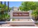 Inviting entrance sign for Villas las Palmas, surrounded by lush palms and desert landscaping at 7635 S Taylor Dr, Tempe, AZ 85284