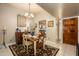 Charming dining room with a wooden table set for a meal, chandelier, and art, adjacent to the kitchen at 7635 S Taylor Dr, Tempe, AZ 85284