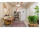 Inviting entryway featuring neutral tones, tiled floors, a ceiling fan, and decorative art and shelving at 7635 S Taylor Dr, Tempe, AZ 85284