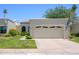 Home exterior with an attached two car garage, well-maintained lawn, and mature landscaping at 7635 S Taylor Dr, Tempe, AZ 85284