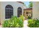 Charming home exterior features arched windows and vibrant desert landscaping for enhanced curb appeal at 7635 S Taylor Dr, Tempe, AZ 85284