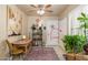 Inviting hallway with decorative rug, adjacent laundry door, table and plant at 7635 S Taylor Dr, Tempe, AZ 85284