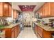 Functional kitchen featuring granite countertops, wood cabinets, and stainless steel appliances at 7635 S Taylor Dr, Tempe, AZ 85284
