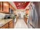 Well-lit kitchen featuring granite countertops, wood cabinets, and stainless steel appliances at 7635 S Taylor Dr, Tempe, AZ 85284