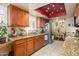 Spacious kitchen featuring granite countertops, wood cabinets, and stainless steel appliances at 7635 S Taylor Dr, Tempe, AZ 85284