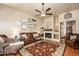 Comfortable living room featuring a fireplace, ceiling fan, and neutral color scheme at 7635 S Taylor Dr, Tempe, AZ 85284