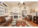 Cozy living room with leather furniture, a fireplace, hardwood floors, and tasteful nautical-themed decor at 7635 S Taylor Dr, Tempe, AZ 85284