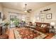 Bright living room with hardwood floors, sliding glass doors to the patio, and a comfortable leather sofa at 7635 S Taylor Dr, Tempe, AZ 85284