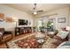 Relaxing living room with a ceiling fan, hardwood floors, a TV, and access to the outdoor patio at 7635 S Taylor Dr, Tempe, AZ 85284