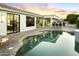 Backyard with a pool, brick patio, and an outdoor bar area, perfect for entertaining at 7774 E San Fernando Dr, Scottsdale, AZ 85255