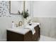 Beautiful bathroom featuring a double vanity with marble countertop and designer fixtures and decorative wall tiles at 7774 E San Fernando Dr, Scottsdale, AZ 85255